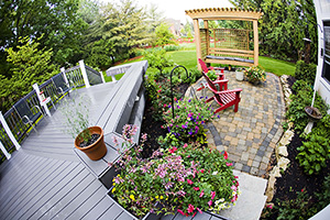 looking down on deck, plants, lush green yard, pergola, paving tiles and other parts of a premium outdoor living area