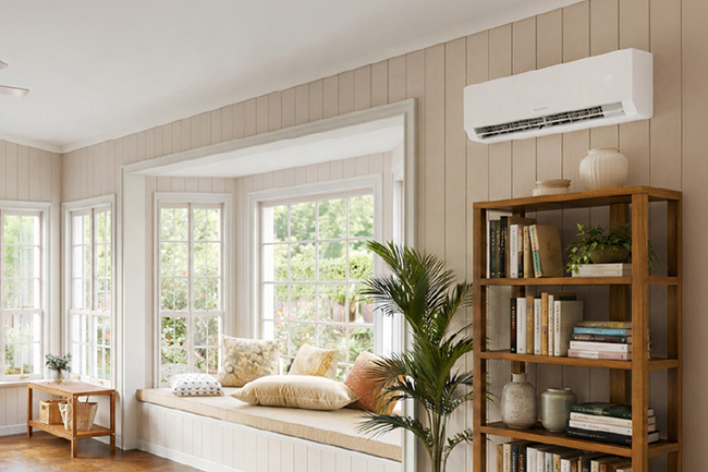view of maybe a living room with a massive window looking onto the backyard, there's a window seat, a green plant and a book shelf filled with family favorites for the yellow dog to relax